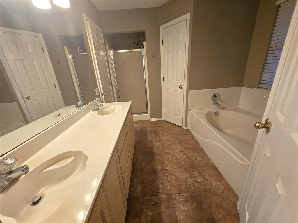 604 Valleyridge Court Decatur, TX 76234 - Photo 16 of 35 a spacious bathroom with a tub sink and mirror
