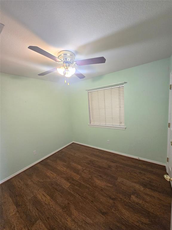 604 Valleyridge Court Decatur, TX 76234 - Photo 21 of 35 an empty room with wooden floor fan and windows