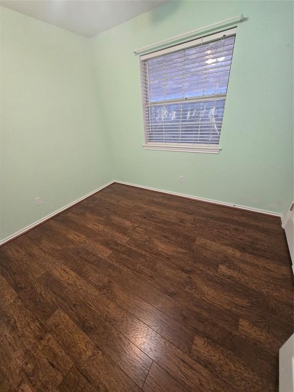 604 Valleyridge Court Decatur, TX 76234 - Photo 23 of 35 an empty room with wooden floor and a window