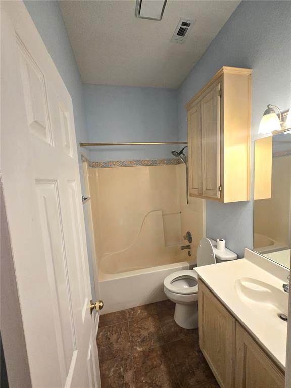 604 Valleyridge Court Decatur, TX 76234 - Photo 24 of 35 a bathroom with a sink a toilet and shower