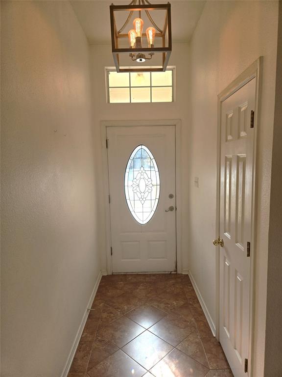 604 Valleyridge Court Decatur, TX 76234 - Photo 4 of 35 an empty room with a window and mirror