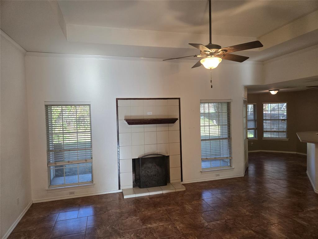 604 Valleyridge Court Decatur, TX 76234 - Photo 31 of 35 a view of a livingroom with a fireplace a ceiling fan and windows