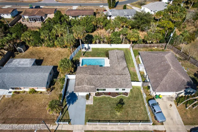 an aerial view of a house with swimming pool