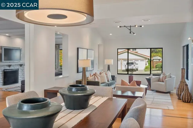 a living room with patio furniture and a potted plant