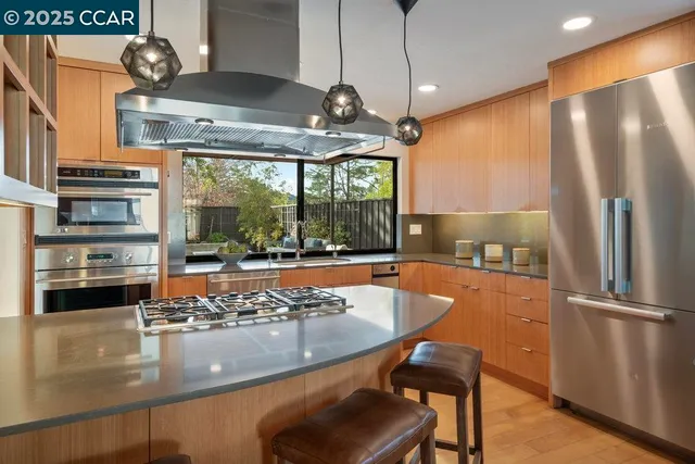 a stove top oven sitting inside of a kitchen
