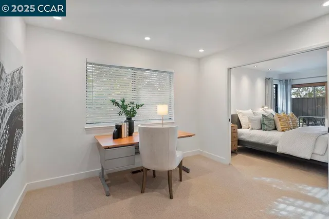 a bedroom with a bed and a painting on the wall