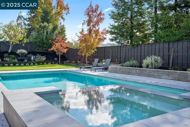 a view of a house with backyard sitting area and garden