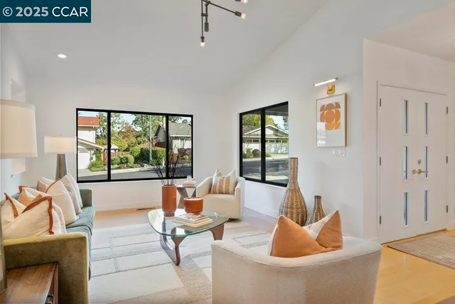 a view of a dining room with furniture wooden floor and a chandelier
