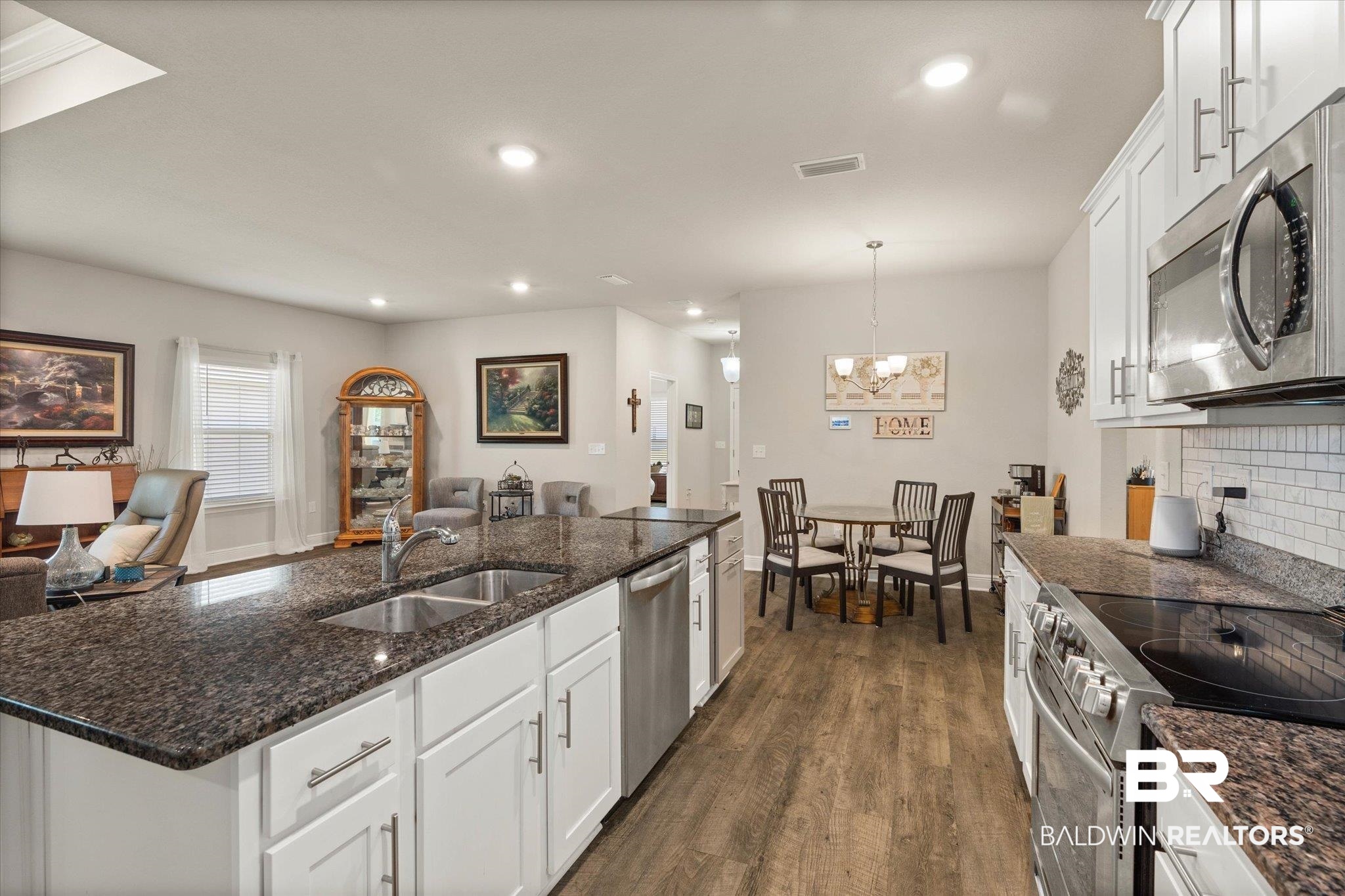 9037 Impala Drive Foley, AL 36535 - Photo 19 of 21 Kitchen featuring open floor plan, stainless steel appliances, dark wood-style floors, recessed lighting, and tasteful backsplash