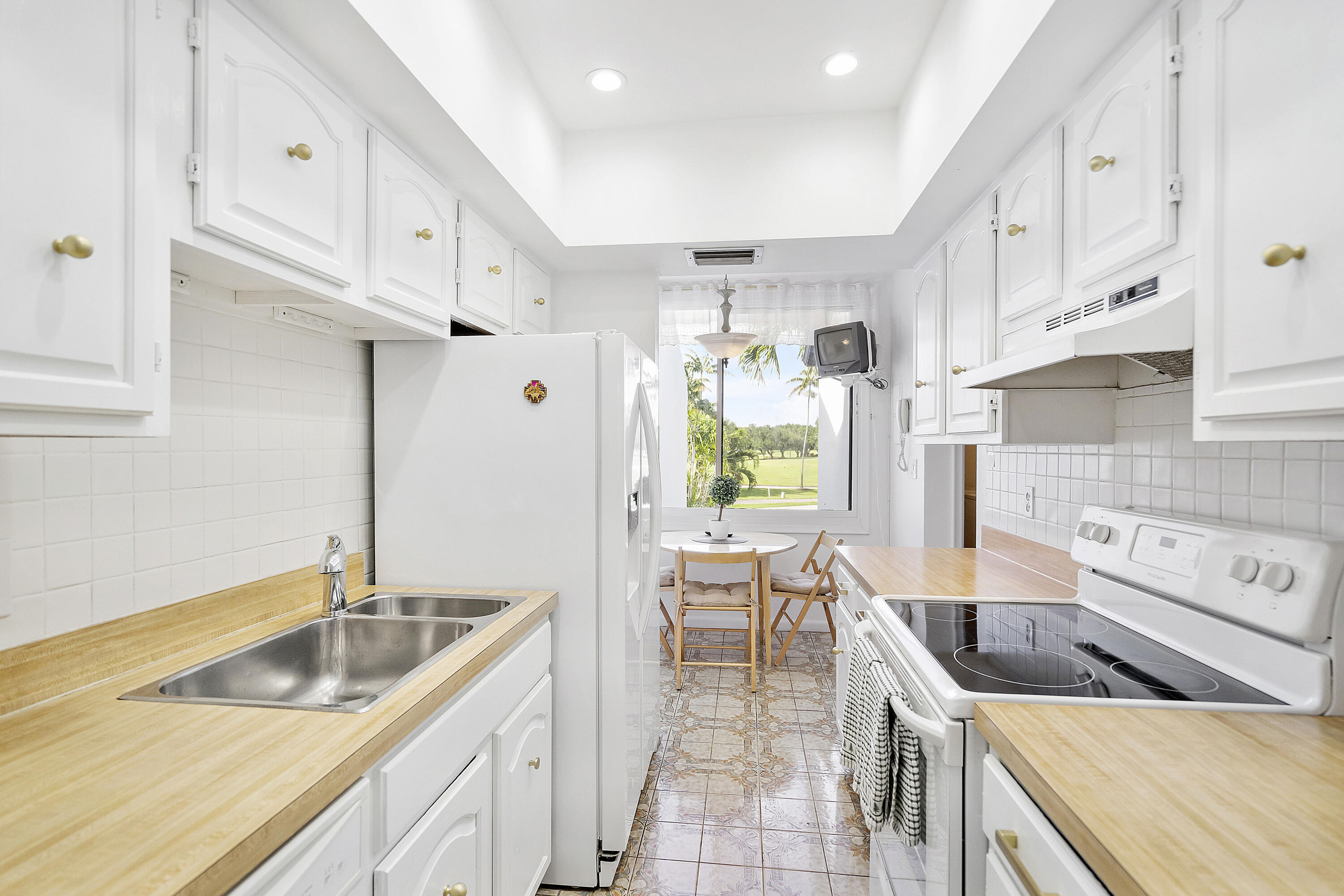 3706 Bridgewood Drive, Unit 3706 Boca Raton, FL 33434 - Photo 14 of 79 a kitchen with stainless steel appliances granite countertop a sink a stove and a refrigerator