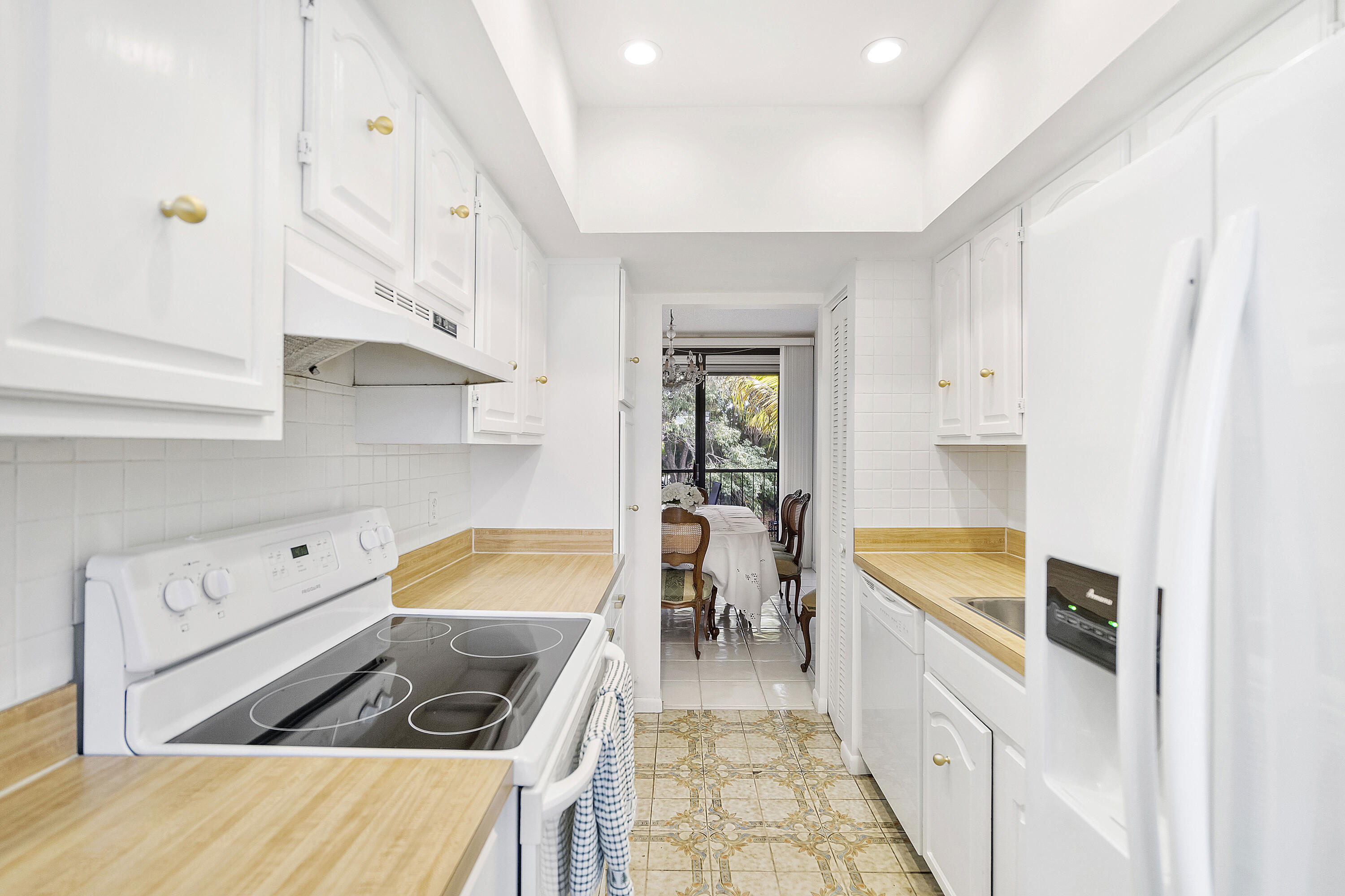 3706 Bridgewood Drive, Unit 3706 Boca Raton, FL 33434 - Photo 16 of 79 a kitchen with stainless steel appliances kitchen island granite countertop a stove and a sink