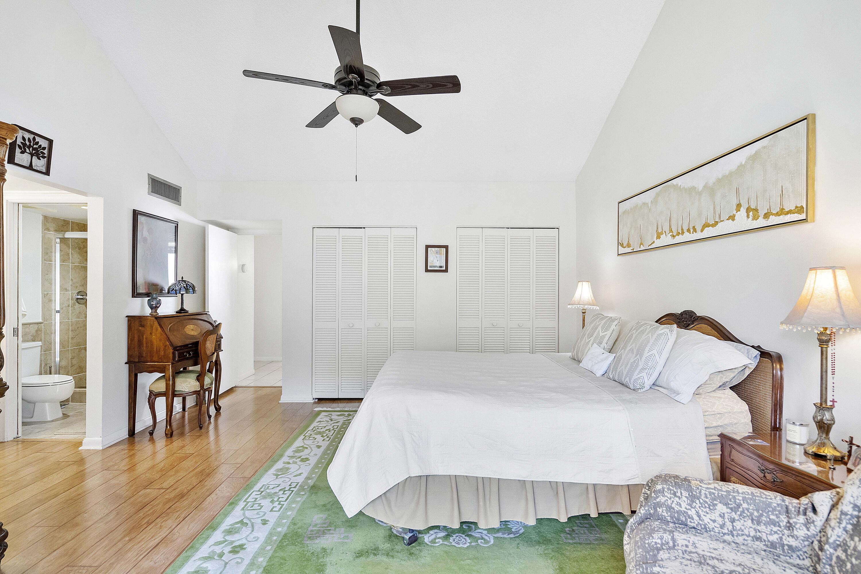 3706 Bridgewood Drive, Unit 3706 Boca Raton, FL 33434 - Photo 25 of 79 a bedroom with a bed and a view of living room