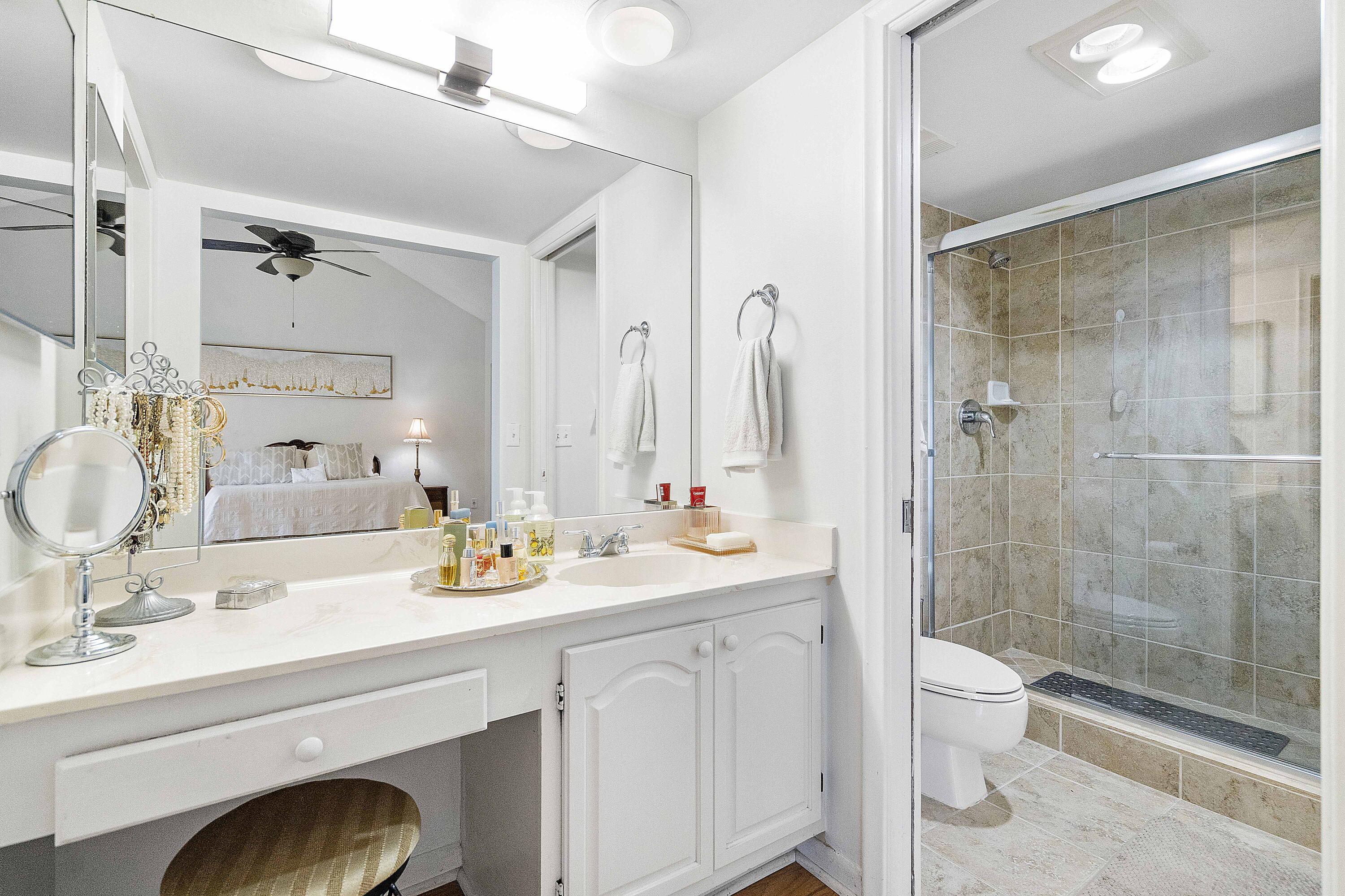3706 Bridgewood Drive, Unit 3706 Boca Raton, FL 33434 - Photo 29 of 79 a bathroom with a sink a toilet and shower