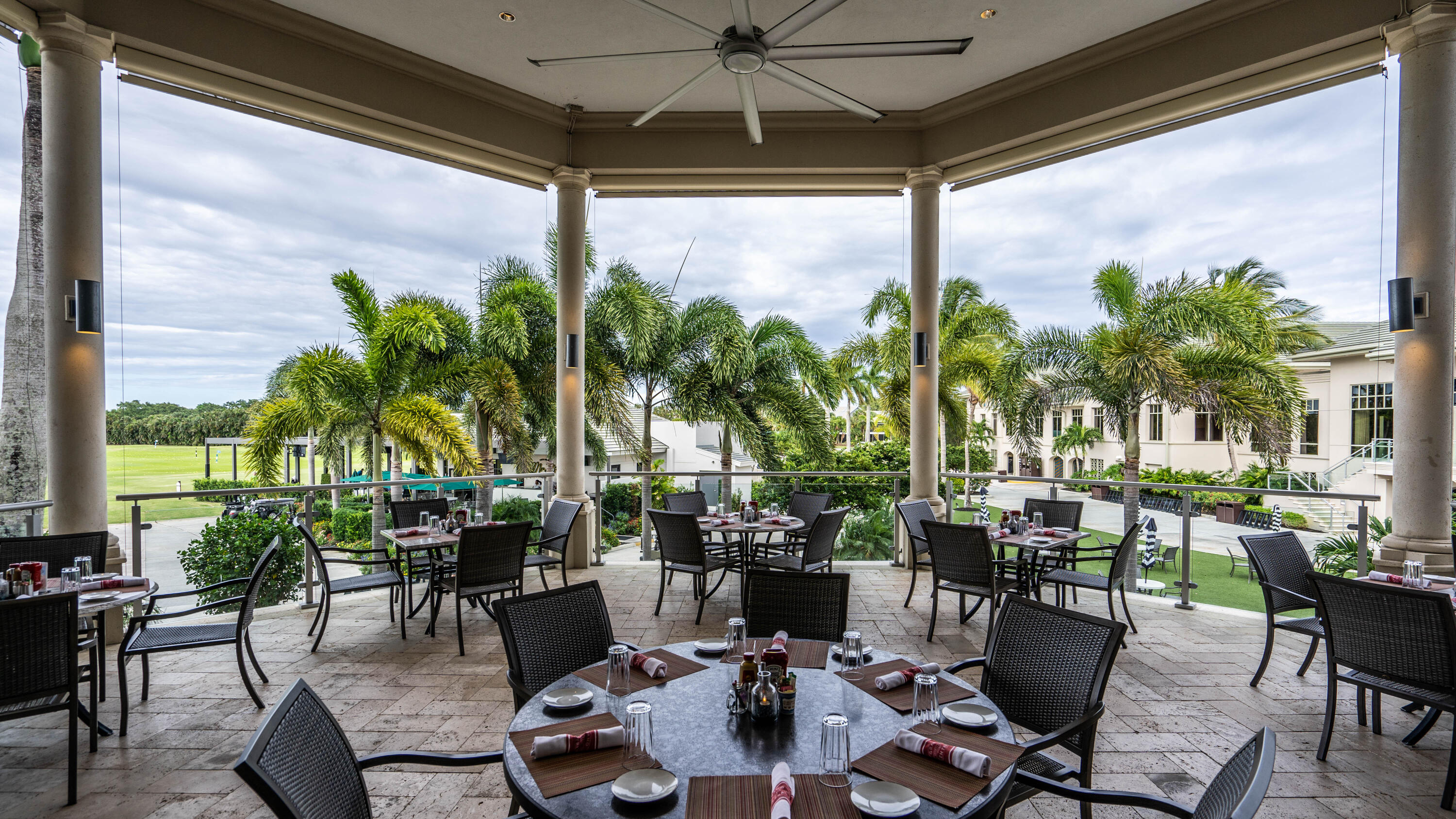 3706 Bridgewood Drive, Unit 3706 Boca Raton, FL 33434 - Photo 67 of 79 a view of a patio with table and chairs potted plants and palm tree