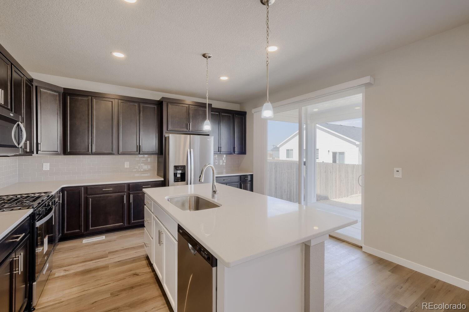 471 Atchison Way Calhan, CO 80808 - Photo 14 of 31 a kitchen with a sink appliances and cabinets