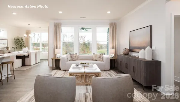 a living room with furniture and large windows