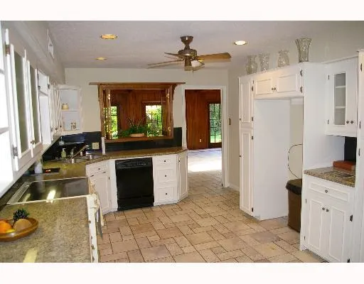 a kitchen with a refrigerator and a sink