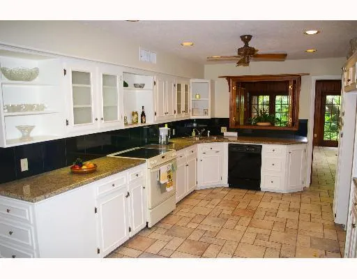 a kitchen with a sink window and cabinets
