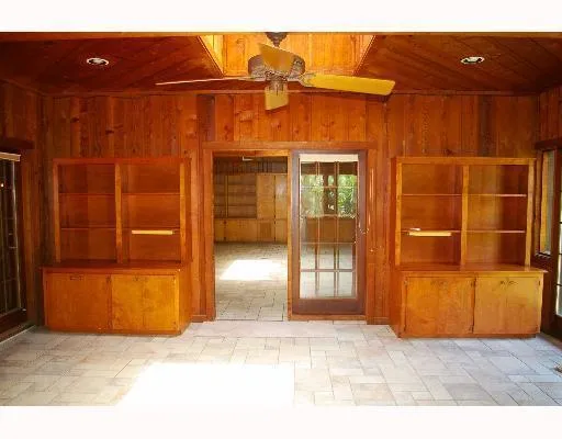 a view of empty room with wooden floor and fireplace