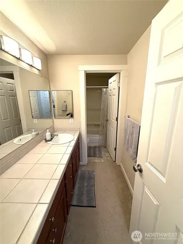 a bathroom with a granite countertop shower and a toilet