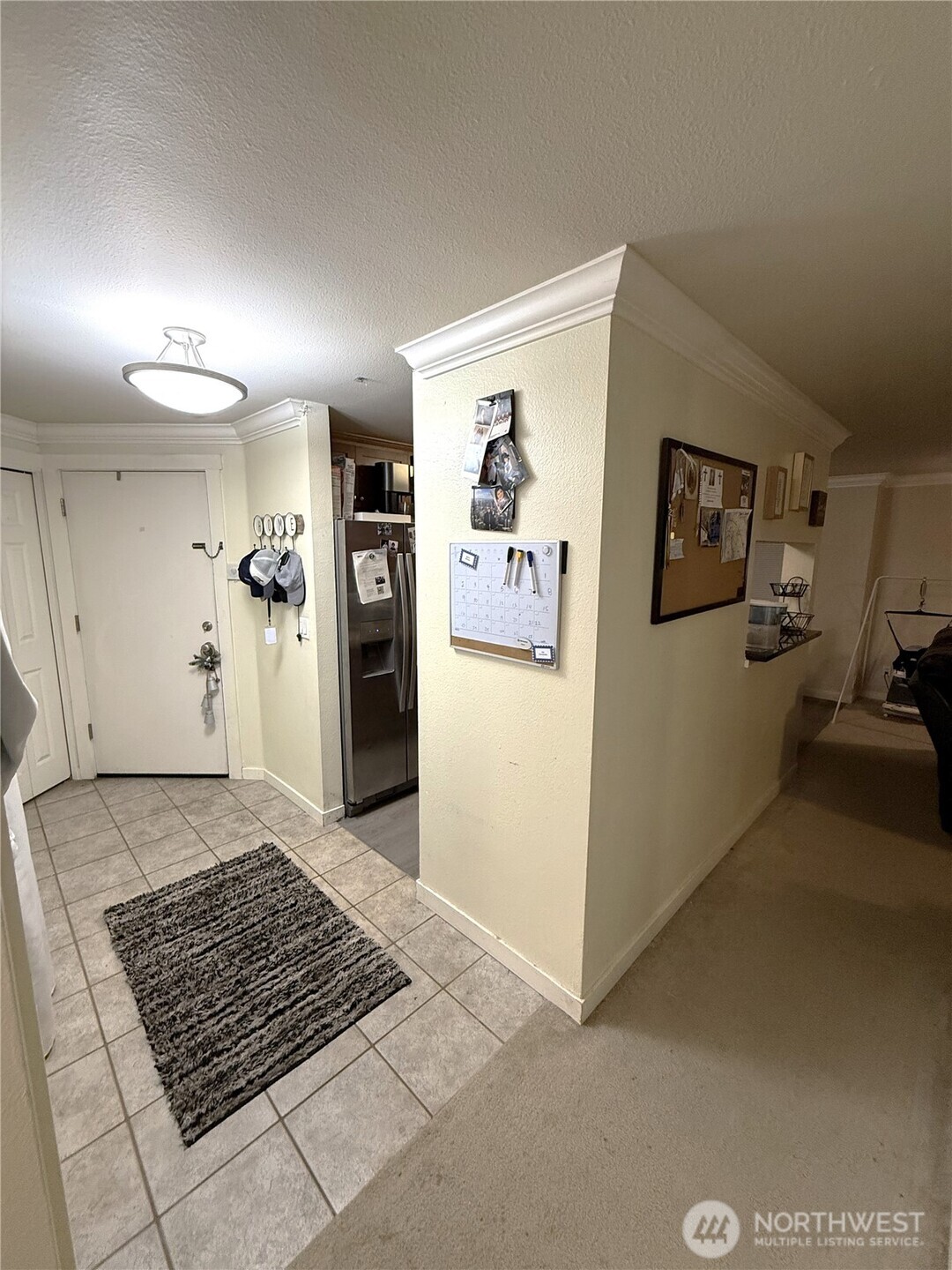 28716 18th Avenue South, Unit Y203 Federal Way, WA 98003 - Photo 3 of 37 a view of a livingroom with wooden floor and a refrigerator