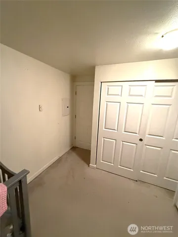 a bedroom with a bed and a night stand