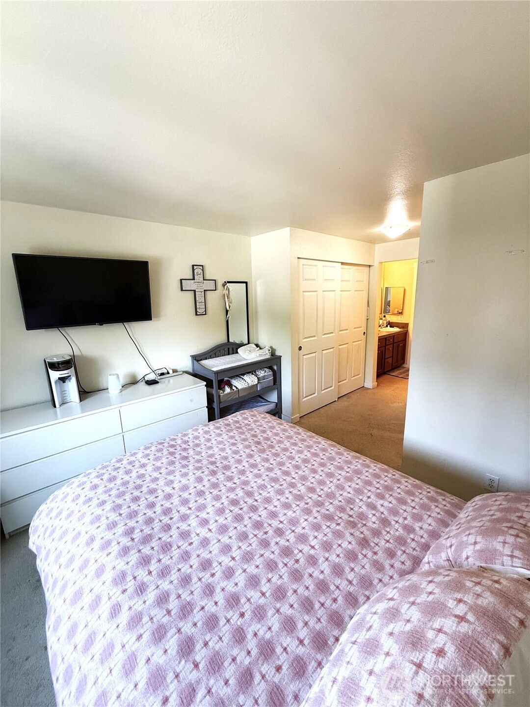 28716 18th Avenue South, Unit Y203 Federal Way, WA 98003 - Photo 36 of 37 a bedroom with a bed and a flat tv screen on dresser