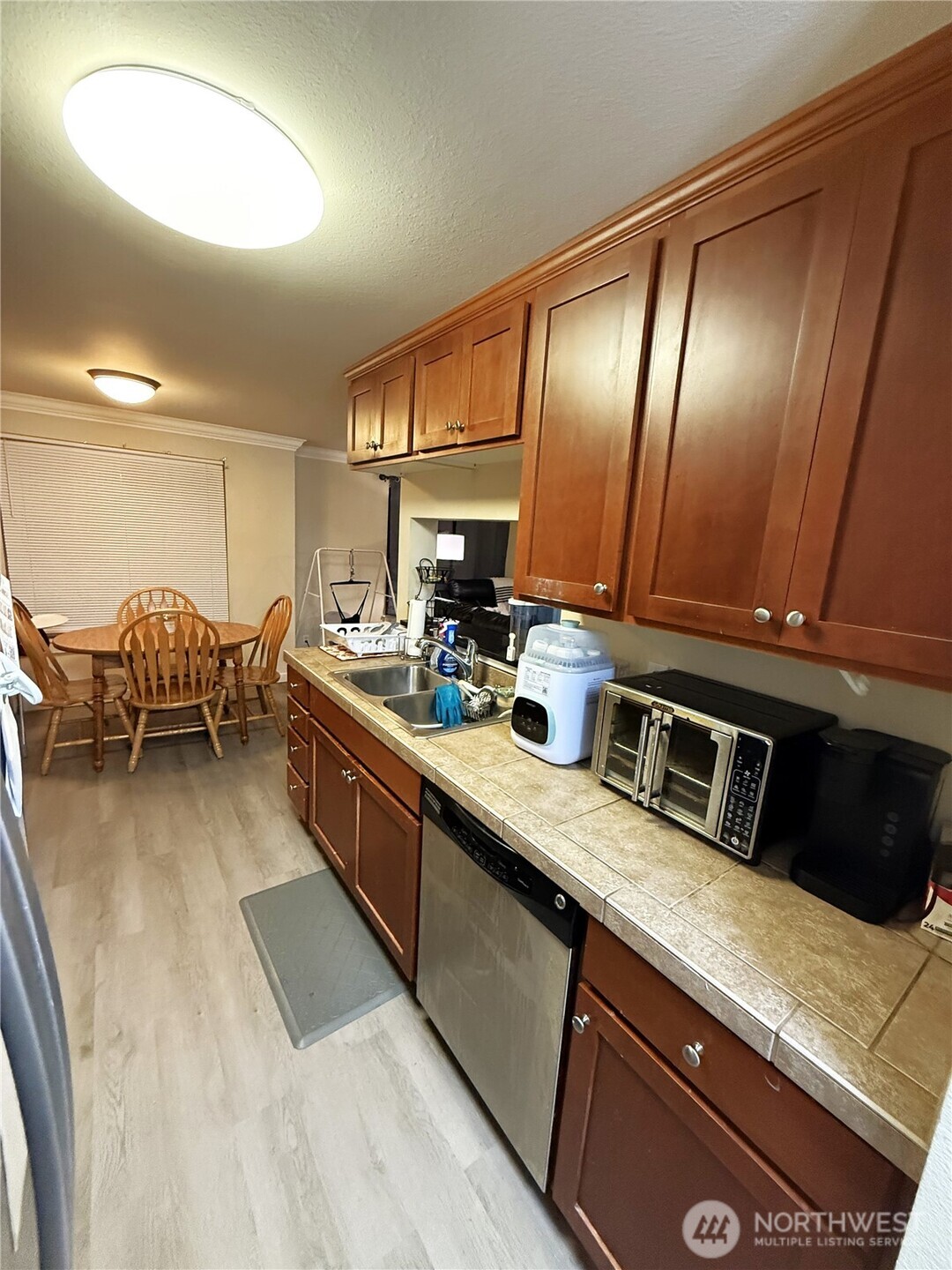 28716 18th Avenue South, Unit Y203 Federal Way, WA 98003 - Photo 5 of 37 a kitchen with stainless steel appliances granite countertop sink stove and cabinets