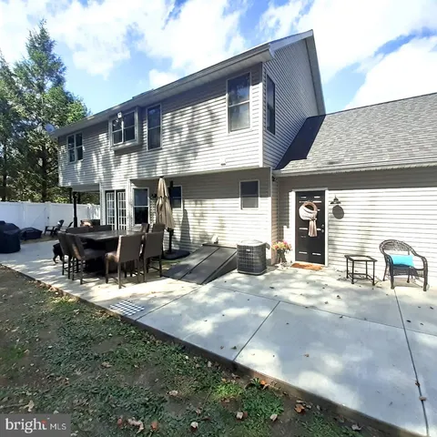 a view of a house with backyard porch and sitting area