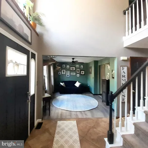 a view of a porch with a table and chairs