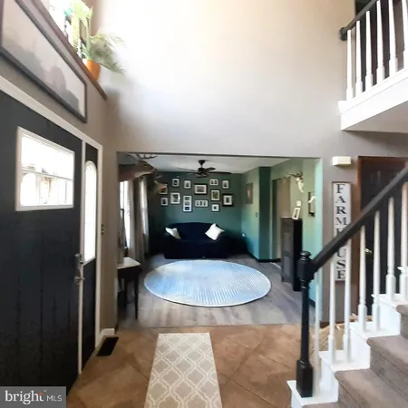 a view of a porch with a table and chairs