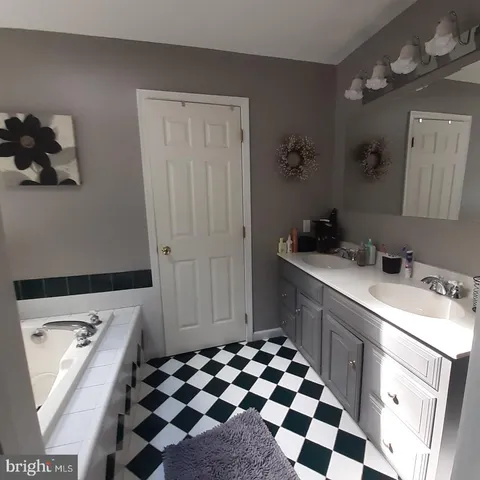 a room with a sink and a mirror
