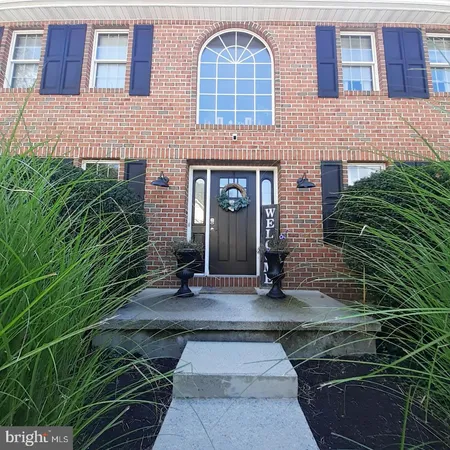 a view of a brick house with many windows