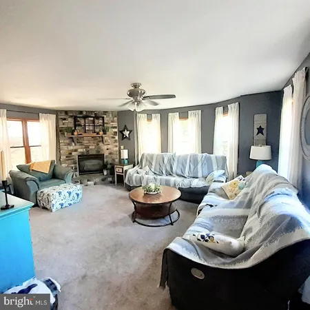 a living room with furniture and a fireplace