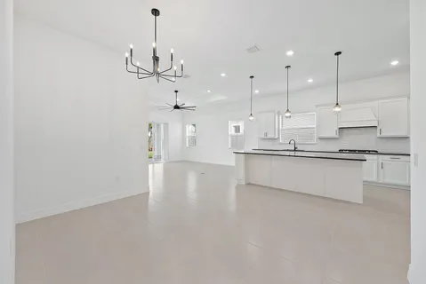 a view of a room with a ceiling fan and shower