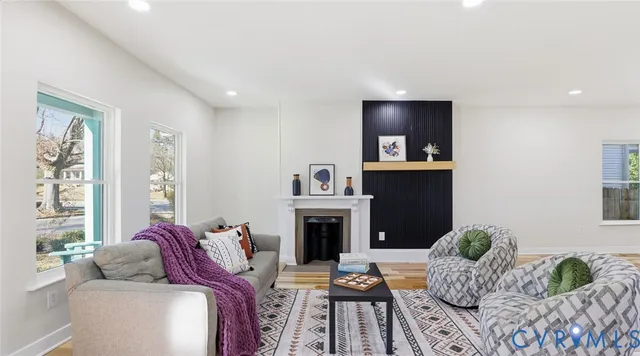 a living room with furniture and a fireplace