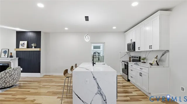 a view of a hallway with furniture and a potted plant