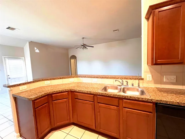 a view of a big room with wooden floor and a window