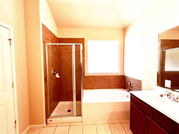 a bathroom with a tub sink and a mirror
