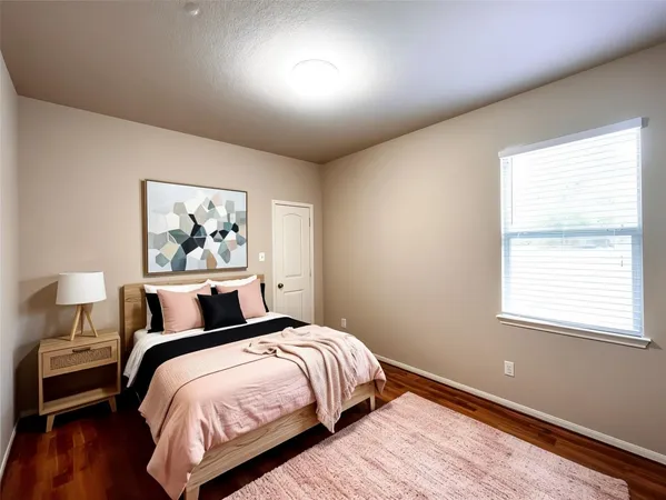 a bedroom with bed and lamps with wooden floor