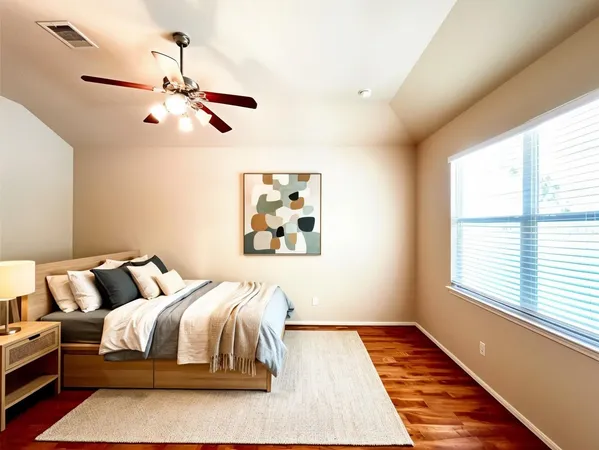 a bedroom with bed and wooden floor