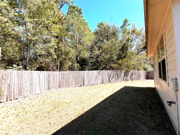 a view of wooden fence and a yard