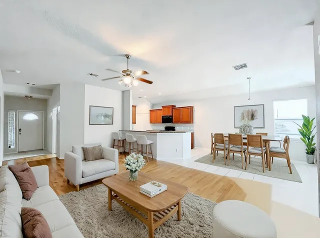 a view of a room with wooden floor and fan