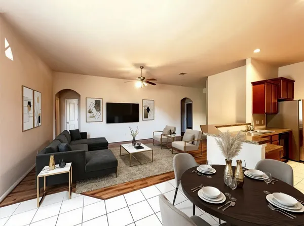 a living room with furniture and wooden floor