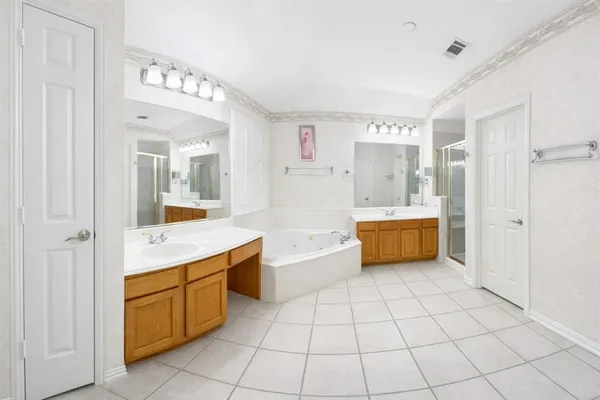 a large white kitchen with a stove a sink dishwasher and a refrigerator