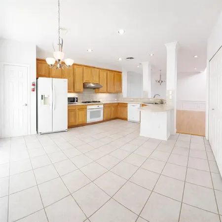 a kitchen with a sink a stove a refrigerator and cabinets