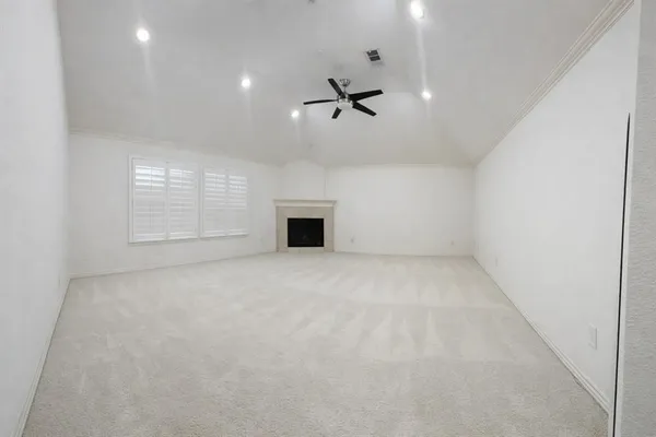 an empty room with a empty space and windows