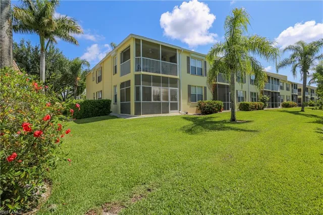 a front view of building with yard and green space