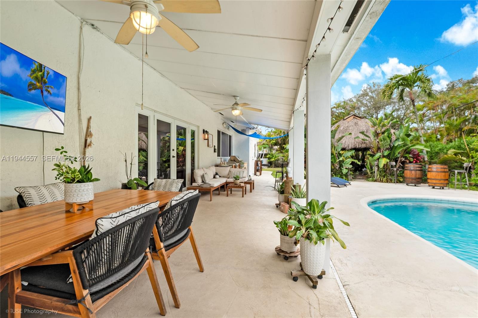 8265 Southwest 119th Street Miami, FL 33156 - Photo 21 of 34 a view of a patio with a table and chairs and potted plants