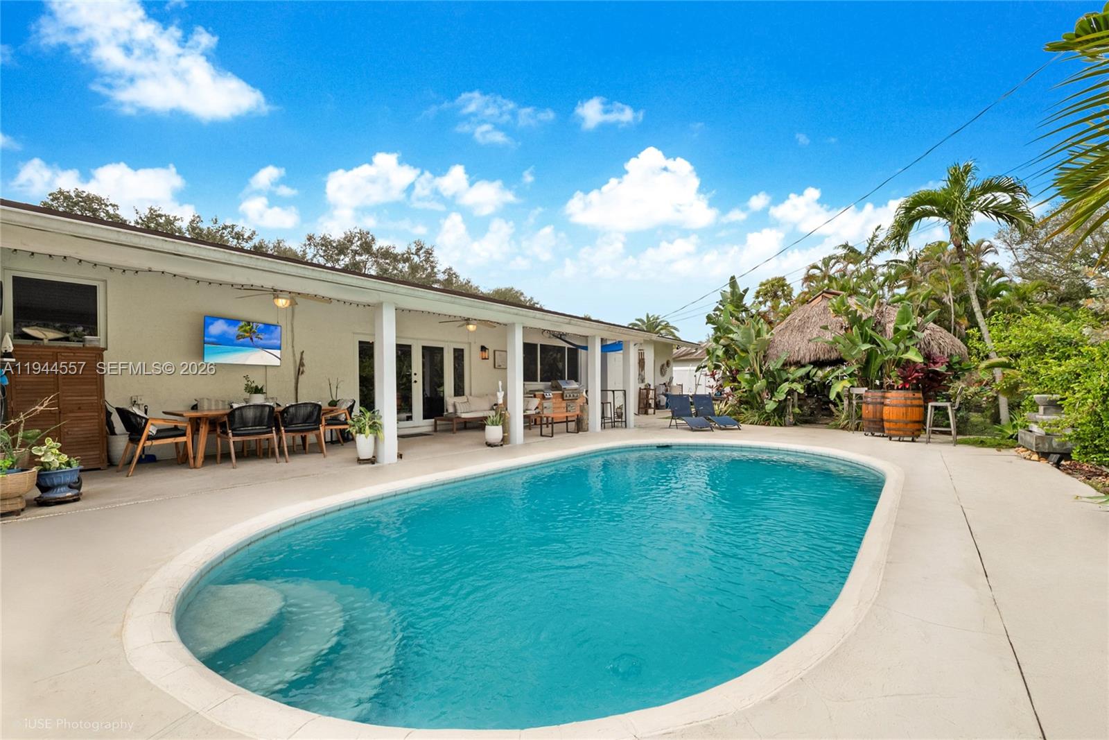 8265 Southwest 119th Street Miami, FL 33156 - Photo 22 of 34 a view of a house with swimming pool and sitting area